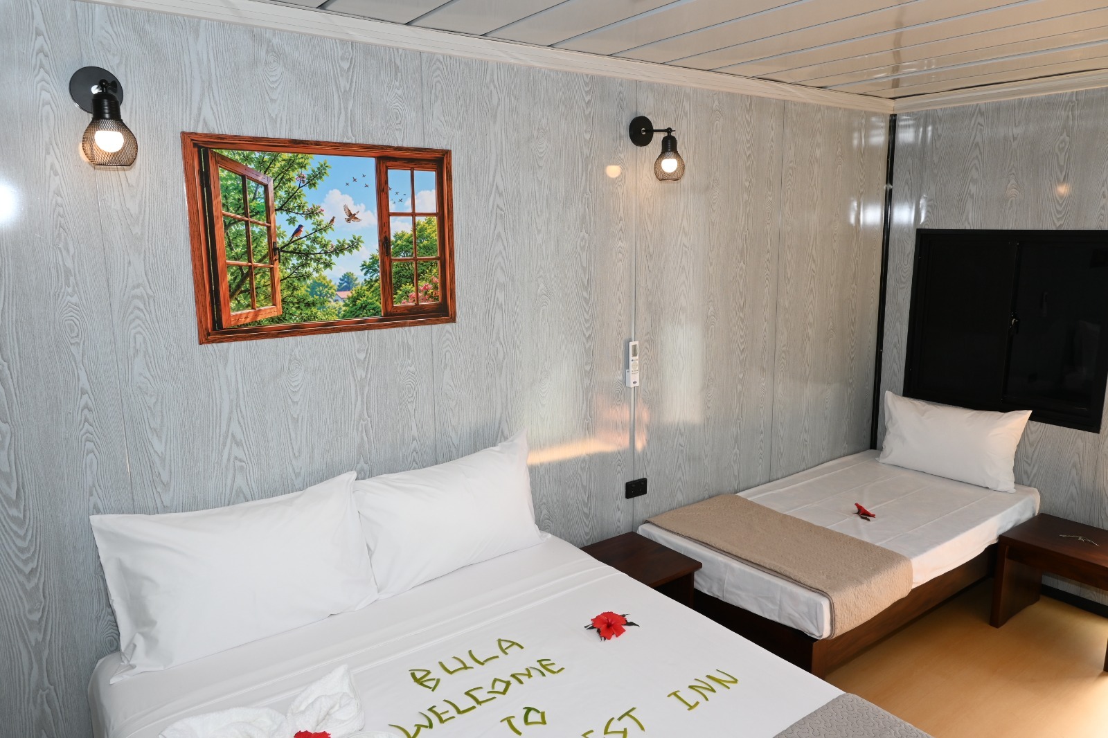 Deluxe Queen Nest with a queen bed and a single bed