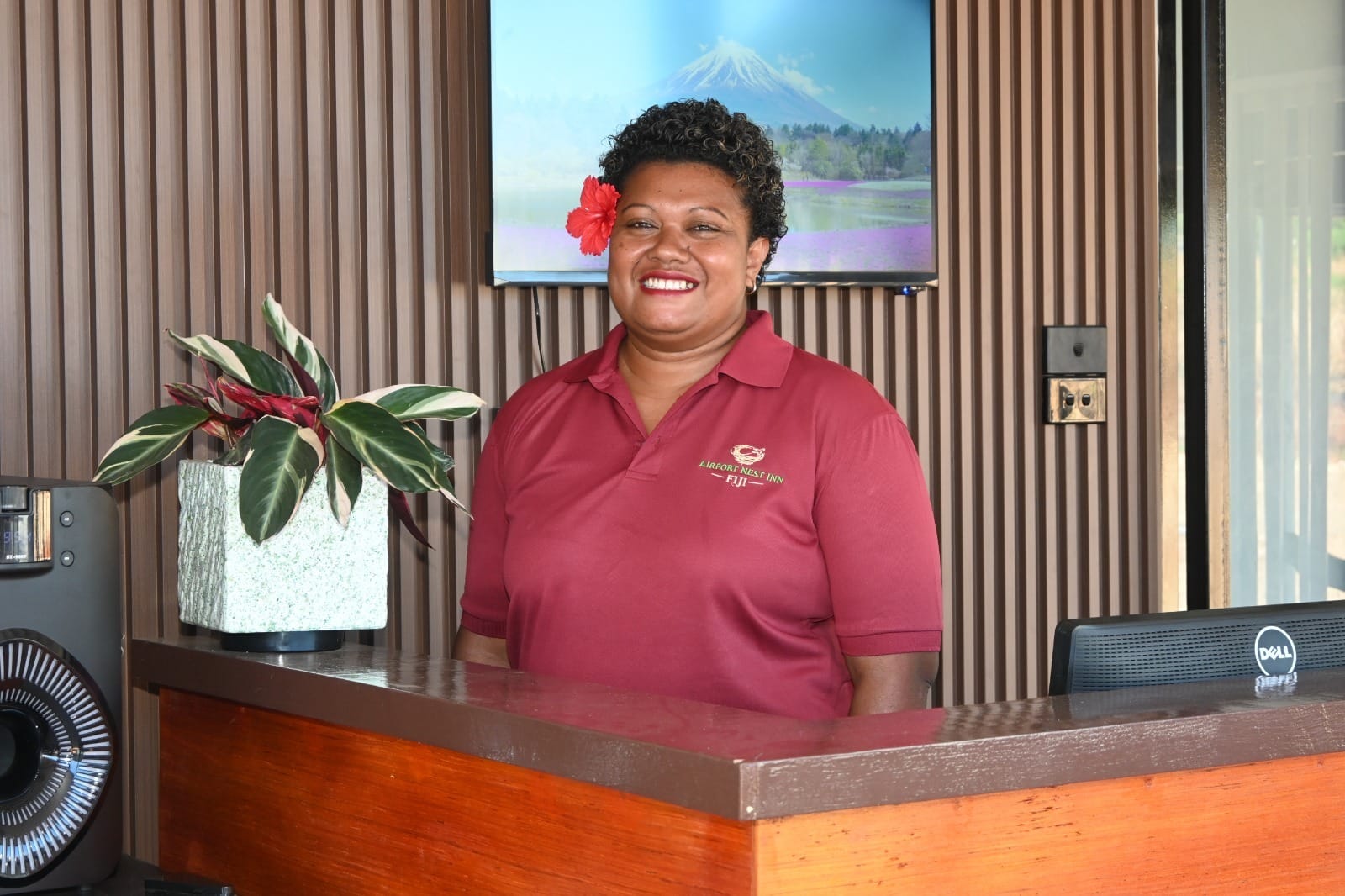The open-air reception desk and bar at Airport Nest Inn